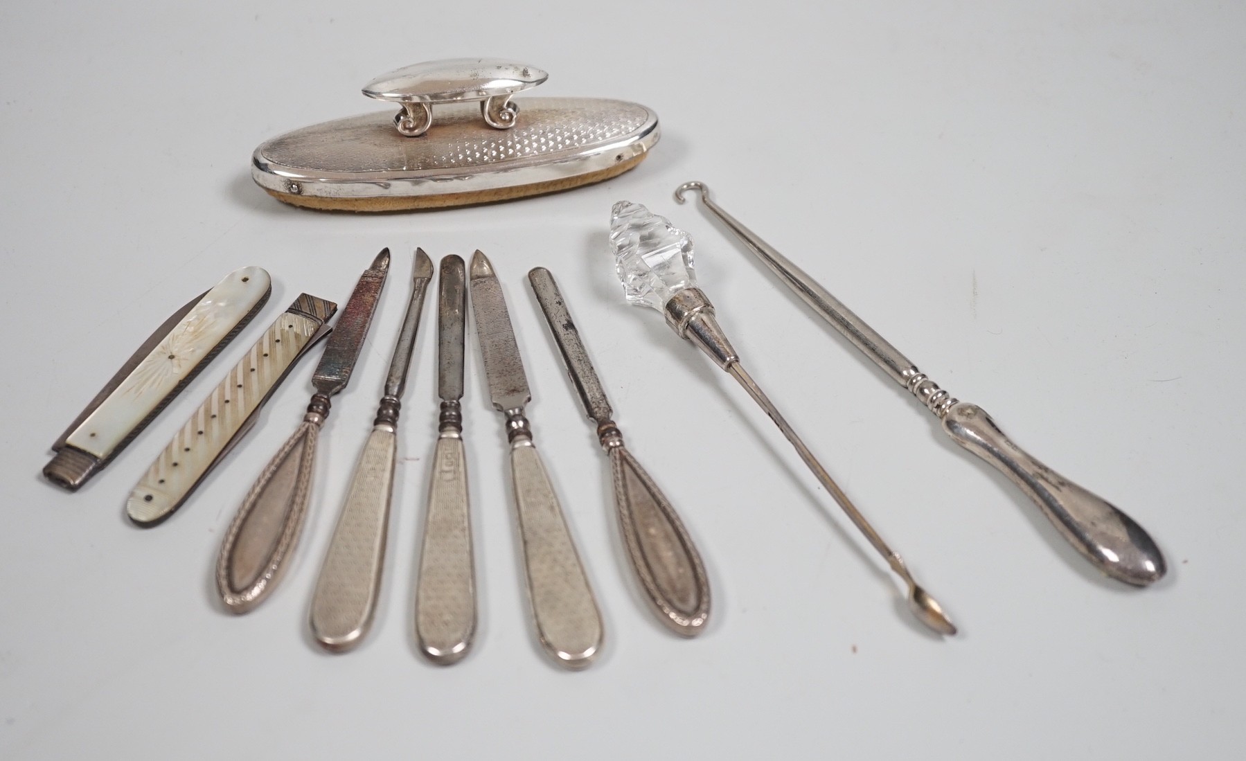 A small group of assorted manicure items and a leather travelling case containing a matched silver and mother of pearl travelling knife and fork.
